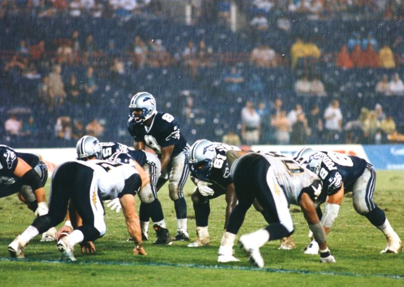 Quarterback Tracy Ham prepares to handle the snap in a rainy game against the Winnipeg Blue Bombers.