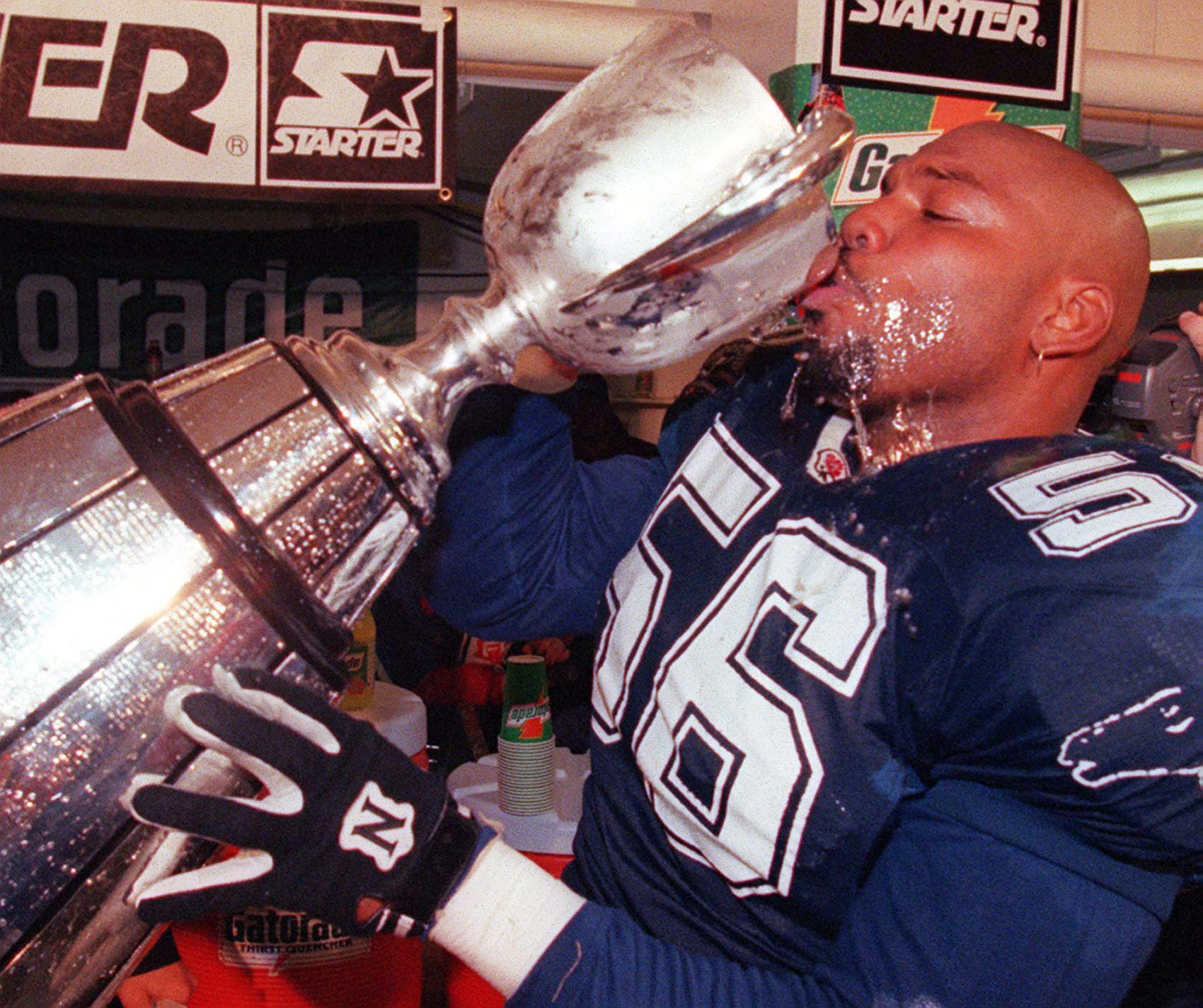 Baltimore Stallions defender Elfrid Payton drinks champagne from the Grey Cup after his team beat Calgary 37-20 in the 1995 Grey Cup final.