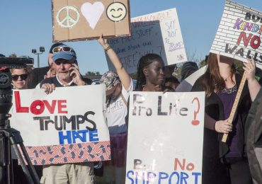 Protestors hold signs at the Trump rally at Stephen Decatur High School in Berlin, Md. Photo by: Rebecca Rainey