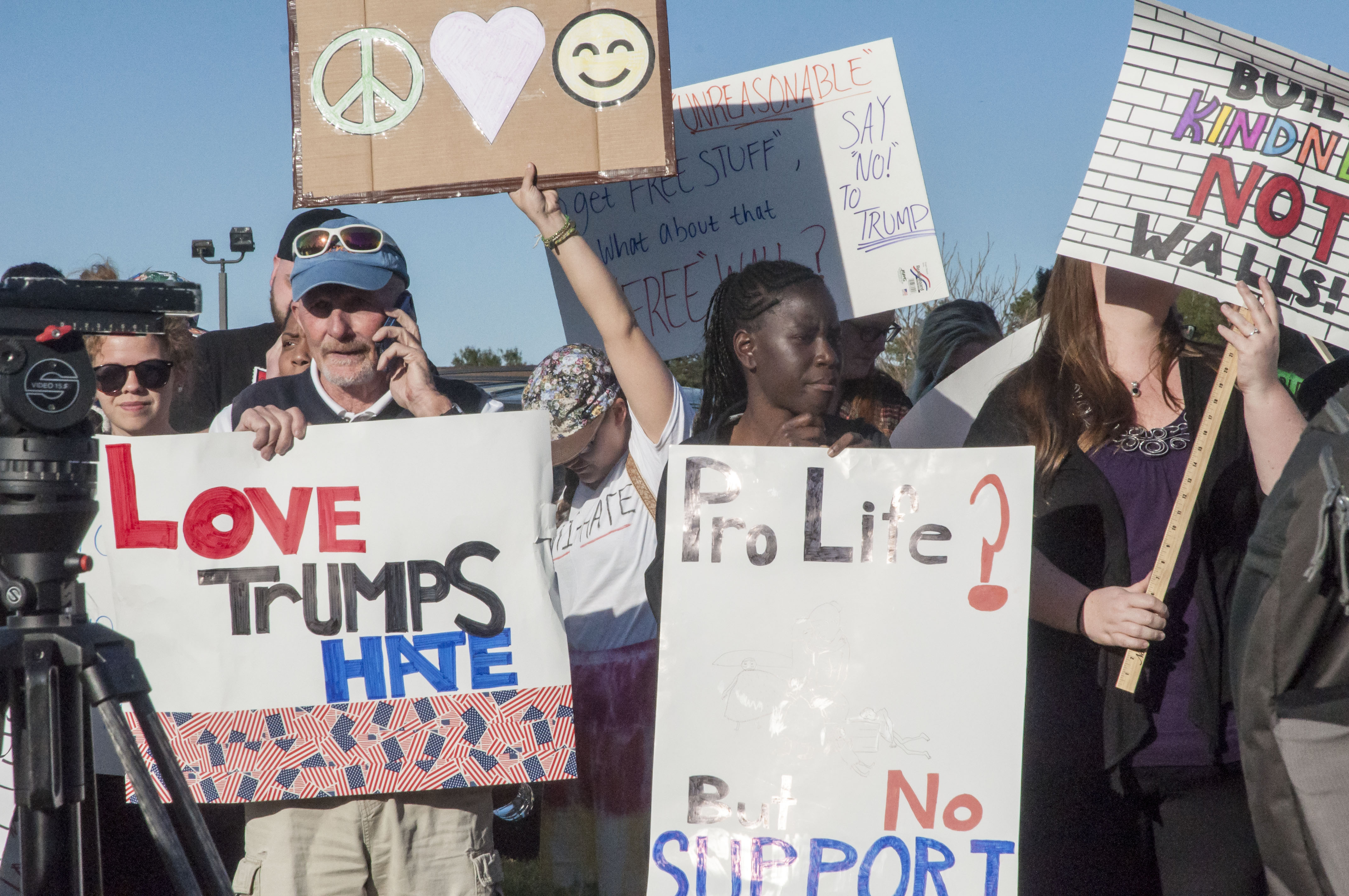 Protestors hold signs at the Trump rally at Stephen Decatur High School in Berlin, Md. Photo by: Rebecca Rainey