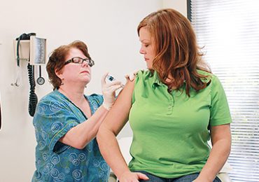 A nurse giving a flu shot to a patient