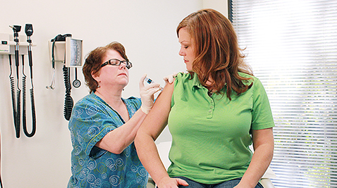 A nurse giving a flu shot to a patient