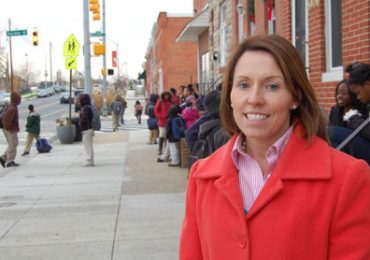 Francis Scott Key Elementary/Middle School Principal Mary McComas supervises students waiting across the street after Friday afternoon dismissal. This is McComas' first year as leader of the school, but she grew up in the neighborhood. By Kate Yoon/Capital News Service