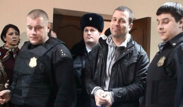 Russian journalist Serghey Reznik, 40, walks out of court in handcuffs. The photo is posted on his LiveJournal blog via user y_shatalov, who writes that Reznik is "a fearless journalist who ridiculed our vicious and rotten power until the very last days!” Credit: Reznik’s LiveJournal blog