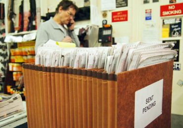 Jack Donald, an employee at Maryland Small Arms Range, Inc. in Upper Marlboro, talks to a customer on the phone on Thursday. Maryland has a seven-day waiting period before purchasers can receive their firearms. (photo by Rashee Raj Kumar/Capital News Service).