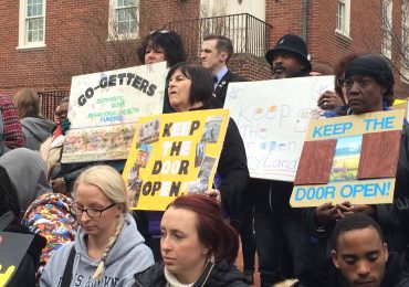 Ralliers hold signs showing support for the Keep The Door Open Act, which would require the state to increase funding for behavioral health care yearly with the rate of inflation, in Annapolis on Thursday, February 25, 2016. (Capital News Service photo by Leo Traub)