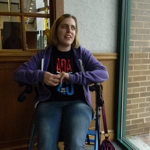 Cheryl Gottlieb, 30, waits for her ride from Maryland Transit Administration’s Mobility service in Towson so she can go to an art class. Gottielb has spastic cerebral palsy, which makes it difficult for her to stand for long periods of time or walk without support. Capital News Service photo by Grace Toohey.