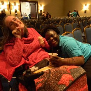 Amanda Lay (left), of Rockville, and her friend and caregiver Portia Acheompong support lobbying day for people with Intellectual and Developmental Disabilities and their advocates in the Loews Hotel in Annapolis on February 19, 2015. Lay is hoping the state will restore the money promised for support services to people with developmental disabilities. She has cerebral palsy. (Capital News Service Photo by Grace Toohey)