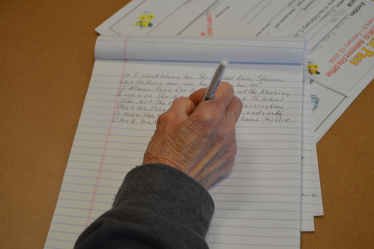 Vonda Wagner, 59, writes the details of her alleged assault and experience in an unlicensed assisted living facility. Wagner underwent surgery for throat cancer and cannot speak. (Capital News Service photo)