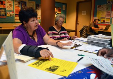 Del. Ana Sol Gutierrez, D-Montgomery County, leading Gaithersburg resident George Ndinu through the voter registration process.