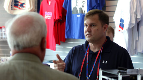 Brian Harlin (right), 45, owner of the Glen Burnie-based GOP Shoppe, assists a customer at the Tampa Bay Times Forum in Tampa, Fla. Harlin is the official campaign merchandise vendor of the 2012 Republican National Convention. (CNS Maryland/Carl Straumsheim)