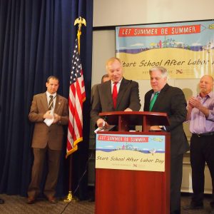 State Comptroller Peter Franchot (center left) welcomes Gov.-elect Larry Hogan’s (center right) support to mandating state public schools begin after Labor Day -- in the Louis L. Goldstein Treasury Building in Annapolis, Maryland, January 15, 2015. Hogan became the 13,244th signature on Franchot’s “Let Summer Be Summer” petition. (Capital News Service photo by Grace Toohey).