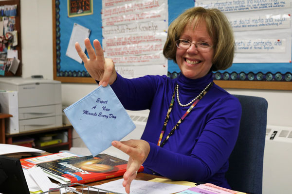 Liz Gilbert, the middle school teacher at Swan Meadow School in Oakland, Md., poses with one of her desk accessories on Wednesday, October 5, 2016. Gilbert has taught at the school for 25 years. (Vickie Connor/Capital News Service)