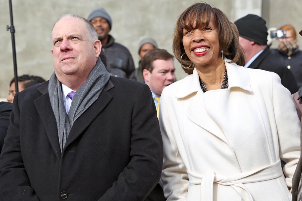 Governor Larry Hogan, left, and Baltimore Mayor Catherine Pugh watch as a row of empty buildings is demolished in Baltimore, Md. on February 10, 2017. The buildings were torn down to make way for revitalized businesses, homes, and mixed use spaces in the area as a part of Project C.O.R.E. (Hannah Klarner/ Capital News Service)