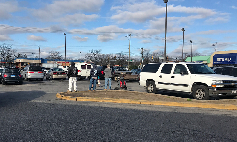 Day laborers await an opportunity to work at Langley Park Plaza. (Capital News Service photo by Gaby Galvin)