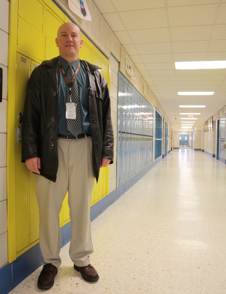 Paul Edwards, a Garrett County commissioner, in the hallway at Northern High School in Accident, Maryland, where he works as the director of secondary education for the county. (Photo by J.F. Meils/Capital News Service)