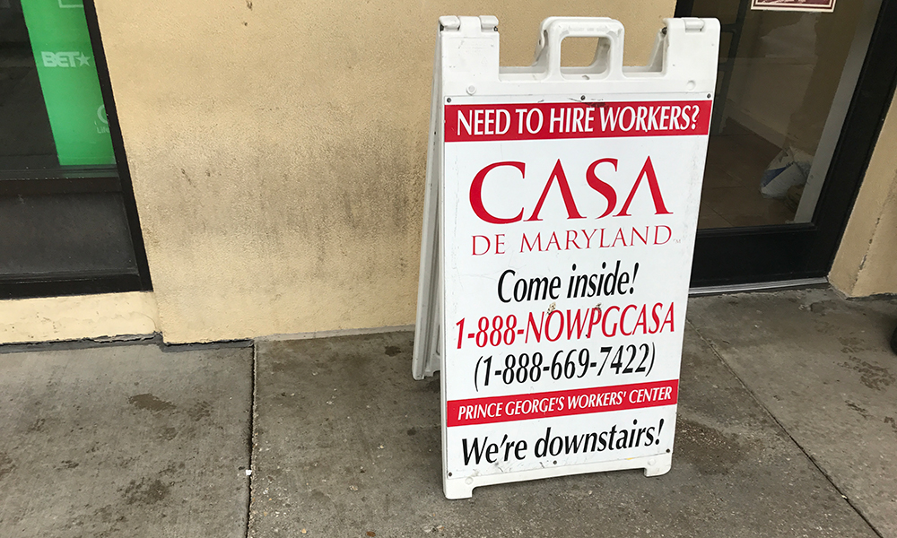 A sign outside the offices of CASA de Maryland, the largest Latino and immigrant advocacy organization in the Washington area. The organization says companies and homeowners who hire workers sometimes short-change them. (Capital News Service photo by Gaby Galvin)