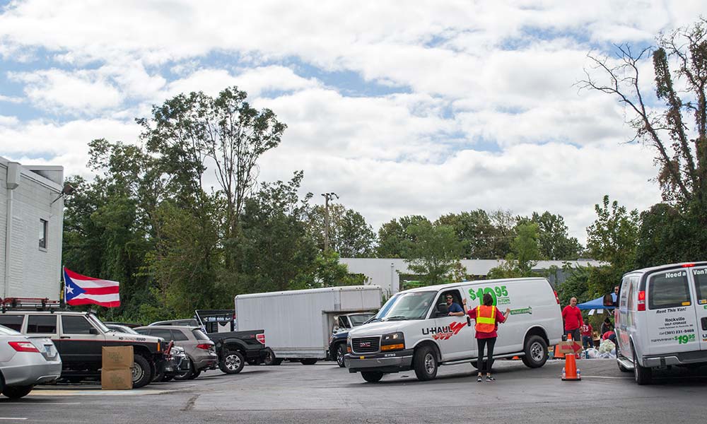 Carolyn Faria directs a moving van at the Rockville site