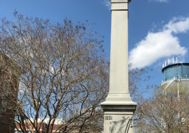 Erected in 1911, the 30-foot granite monument stands in Elizabeth City, N.C. The south side features a Confederate battle flag with the words "Our Heroes." Capital News Service photo.