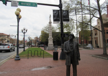 A statue of William C. Whitner, an engineer who helped bring electricity to Anderson, stands in front of a 35-foot Confederate statue. Both are located in front of the Anderson County Courthouse in Anderson City, South Carolina. Capital News Service photo by Lindsey Feingold.