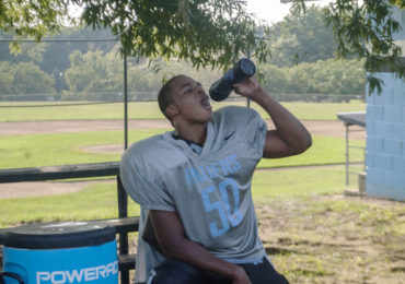 Eleanor Roosevelt High School player Travon Firth takes a water break during practice. (Zach Selby/Capital News Service)