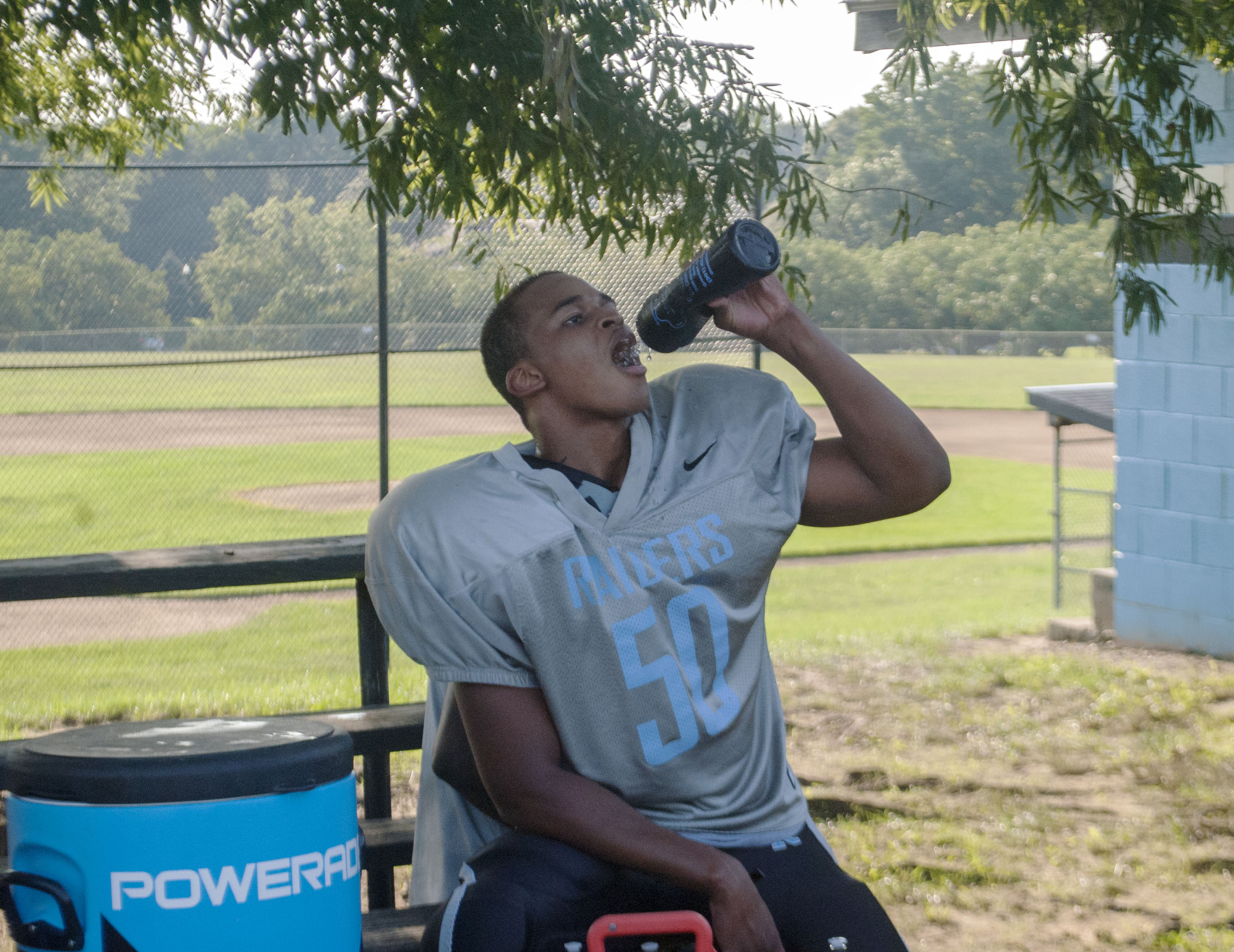 Eleanor Roosevelt High School player Travon Firth takes a water break during practice. (Zach Selby/Capital News Service)