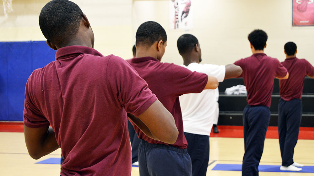 Boys at the Baltimore City Juvenile Justice Center practice yoga to work on mindfulness habits as they wait for placement or trials on Sept. 25, 2018. (Courtesy of Eric Solomon)