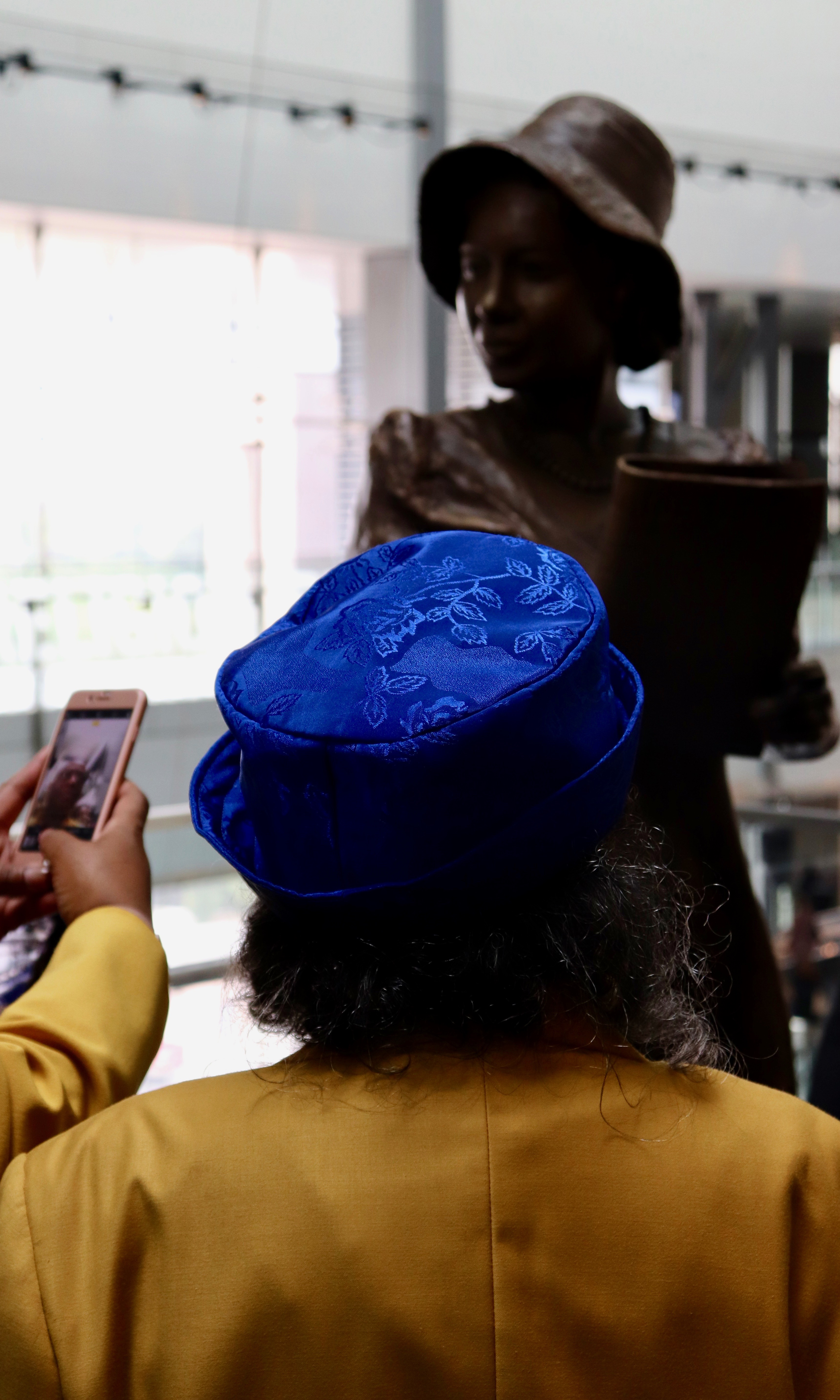 WASHINGTON - One sorority sister has a moment of reflection in front of Alice Allison Dunnigan&#039;s statue (Albane Guichard/Capital News Service)