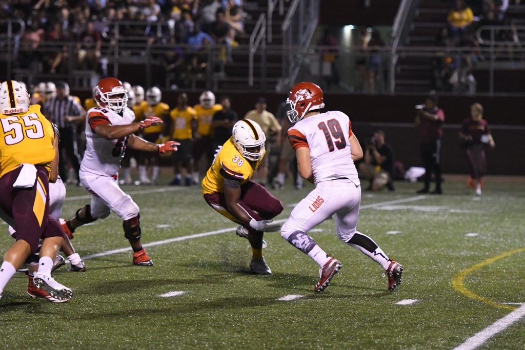 Salisbury University offensive lineman Isaac Johnson (38) makes a move against an opposing lineman and closes in for a sack. (Photo courtesy of Joey Gardner/ FotoJoe)