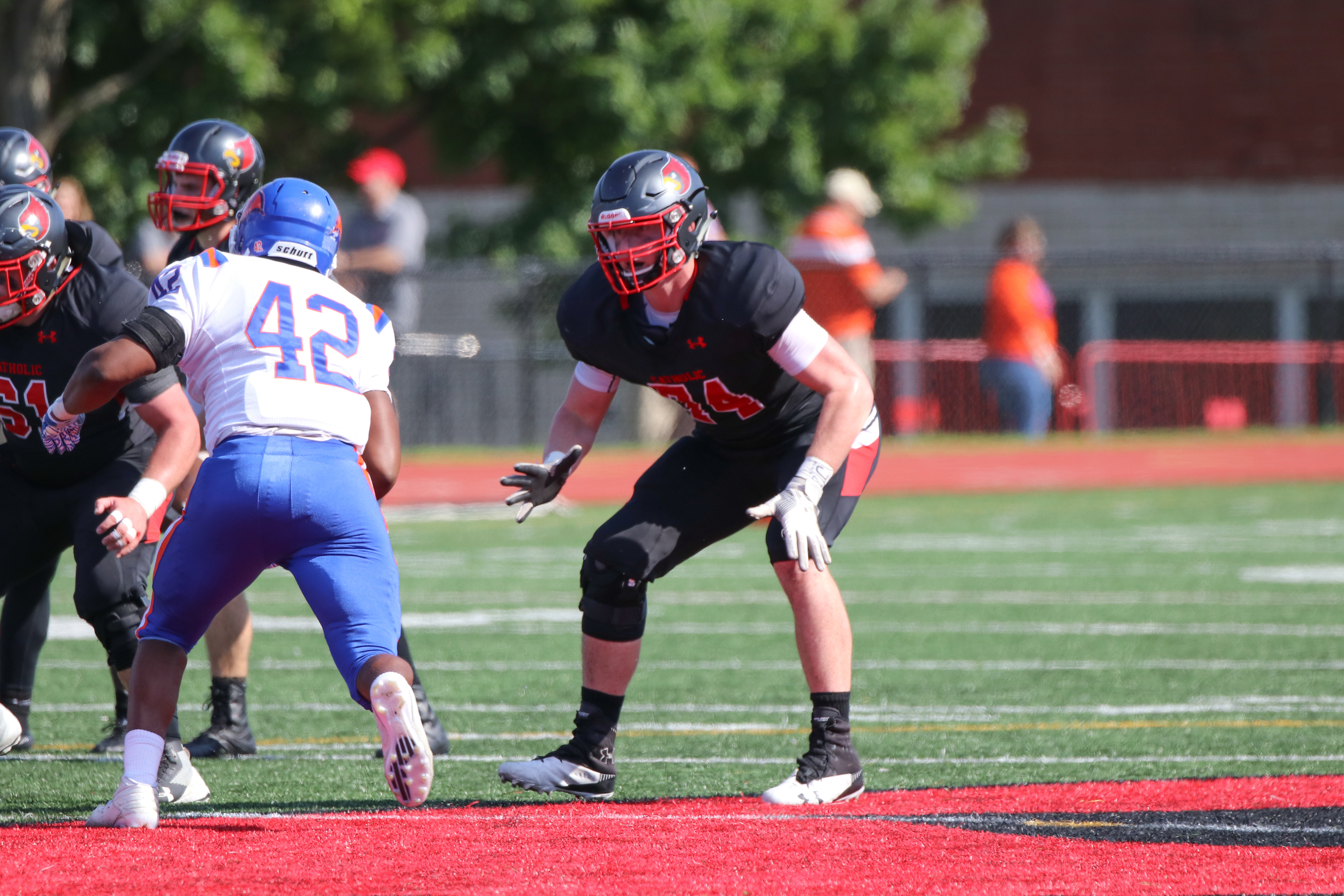 Catholic University of America offensive lineman Mike Zimmerman sets back in a pass block against an opposing defensive end. (Photo courtesy of Joey Gardner/ FotoJoe)