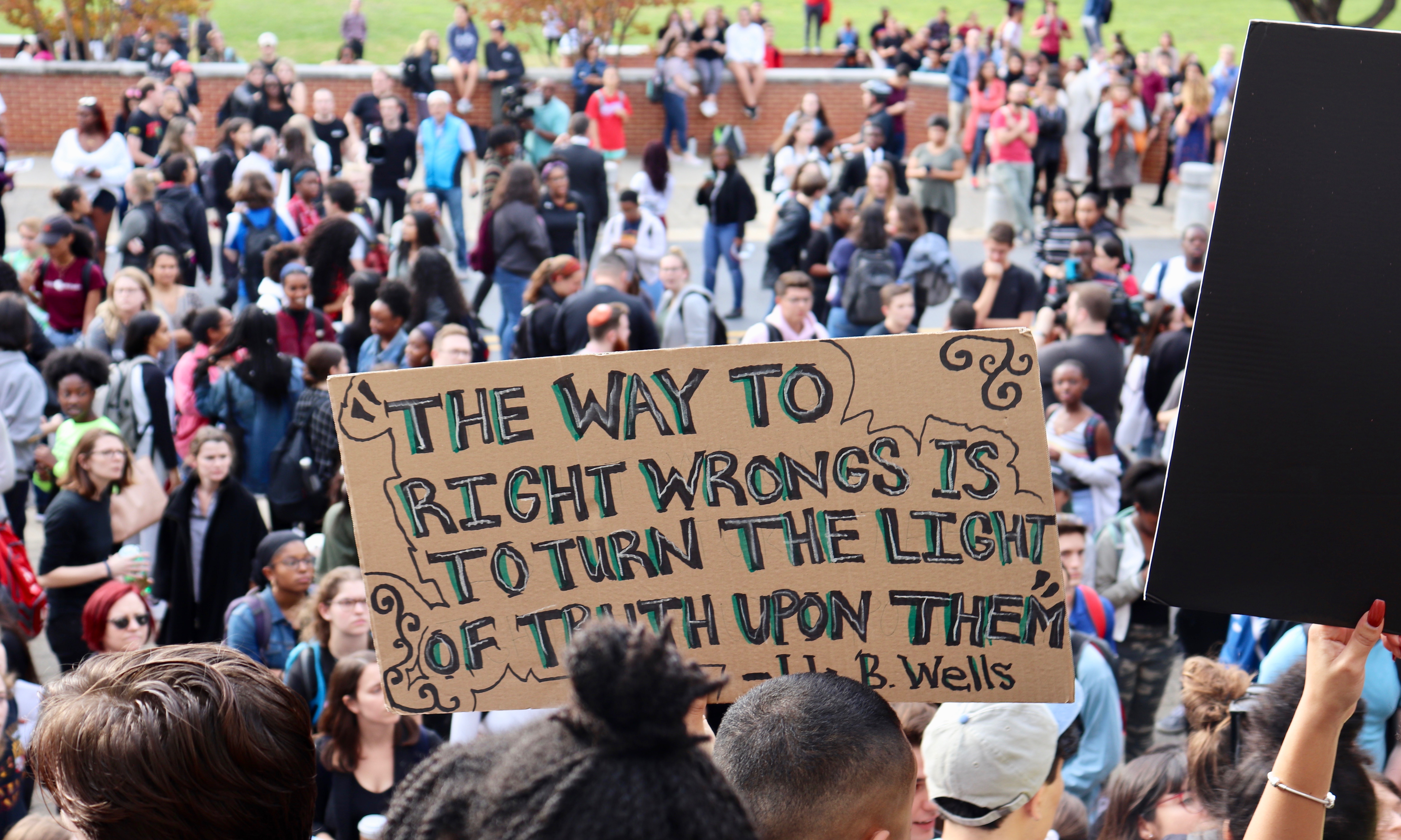 COLLEGE PARK - A sign at a student rally on the University of Maryland campus carries a quote from Ida B. Wells-Barnett: "The way to right wrongs is to turn the light of truth upon them.