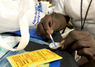 Belinda Barksdale of Bmore POWER, a harm reduction and opioid education group, demonstrates how to use a fentanyl test strip at a distribution event Wednesday, September 11, 2019, at Northeast Market in Baltimore. Cocaine-related deaths have spiked in recent years, due in large part to the proliferation of fentanyl, state health department figures show. (Capital News Service/Ian Round)
