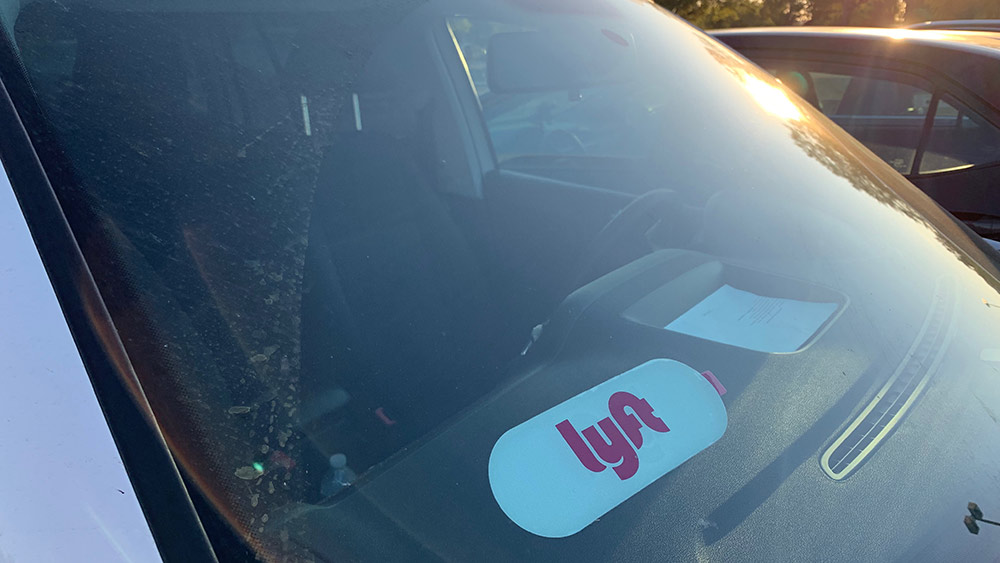 Company decals prominently placed on ride-hailing vehicles help passengers identify their requested rides. (Photo by Eric Myers/Capital News Service)