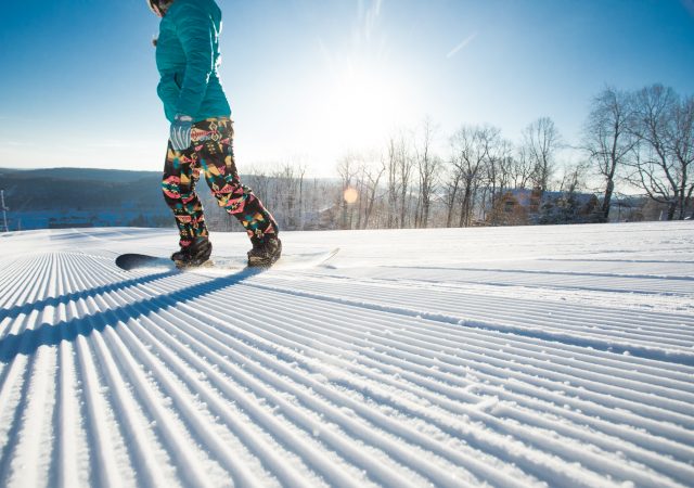 A snowboarder enjoys freshly packed snow at Wisp ski resort.