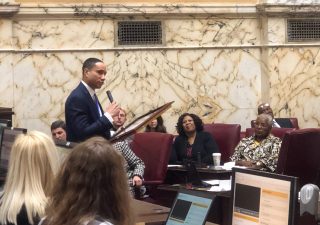 State Sen. William “Will” Smith Jr., D-Montgomery, presents an American flag flown over a United States base in Kabul, Afghanistan, to the Maryland Senate on Friday, January 10, 2020. The flag was flown over the base during his deployment on Sept. 11, 2019. Capital News Service Photo by Ryan E. Little.