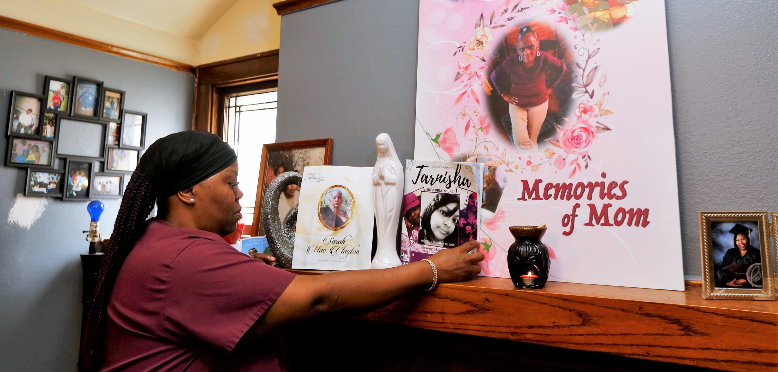 Wyconda Clayton in her home at 2871 N. 45th Street in Milwaukee, Wisconsin, looks over a memorial honoring the sudden passing of three family members just months apart this year. Her mother Eula Clayton died April 14, God-sister Tarnisha Young died May 20, and her oldest sister Sarah Clayton died June 23. (Pat A. Robinson)