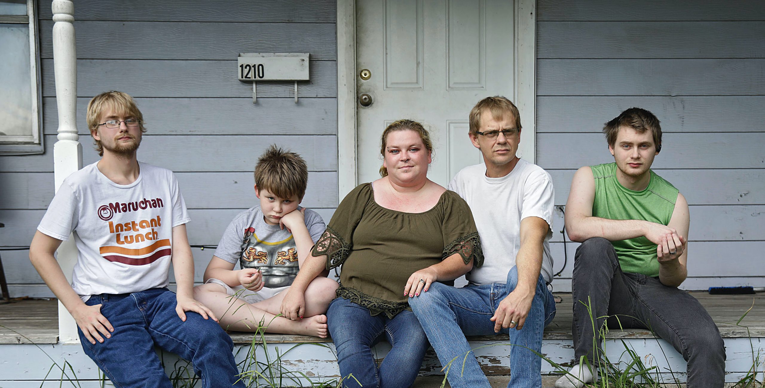 The Myers family is receiving money for rent from The Landlord Tenant Relief Fund in Tulsa after getting an eviction notice. The fund paid their landlord four months’ rent after city officials and nonprofits collaborated to collect public and private money to keep vulnerable renters like the Myerses from being evicted during the pandemic. Five of the six family members -- from left, Duncan, 21, Riley, 9, parents Beth and Jack and Dylan, 20 -- gathered on the front porch of their Tulsa rental home recently. (Mike Simons)