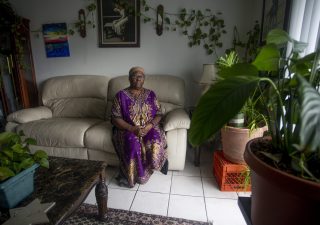 Yochebed Israel, 59, poses for a portrait inside her Tampa, Florida, apartment on Monday, Aug. 17, 2020. Israel, a nursing assistant, found an eviction notice on her door in May after being unable to pay rent since she contracted COVID-19 from her daughter in April, and could not return to work. “There’s a lot of despair in this situation,” Israel said. “Not only are you sick from COVID-19, you miss work, you miss your job, you miss getting paid, you miss a lot of things that dominoes into this situation.” (Ivy Ceballo)