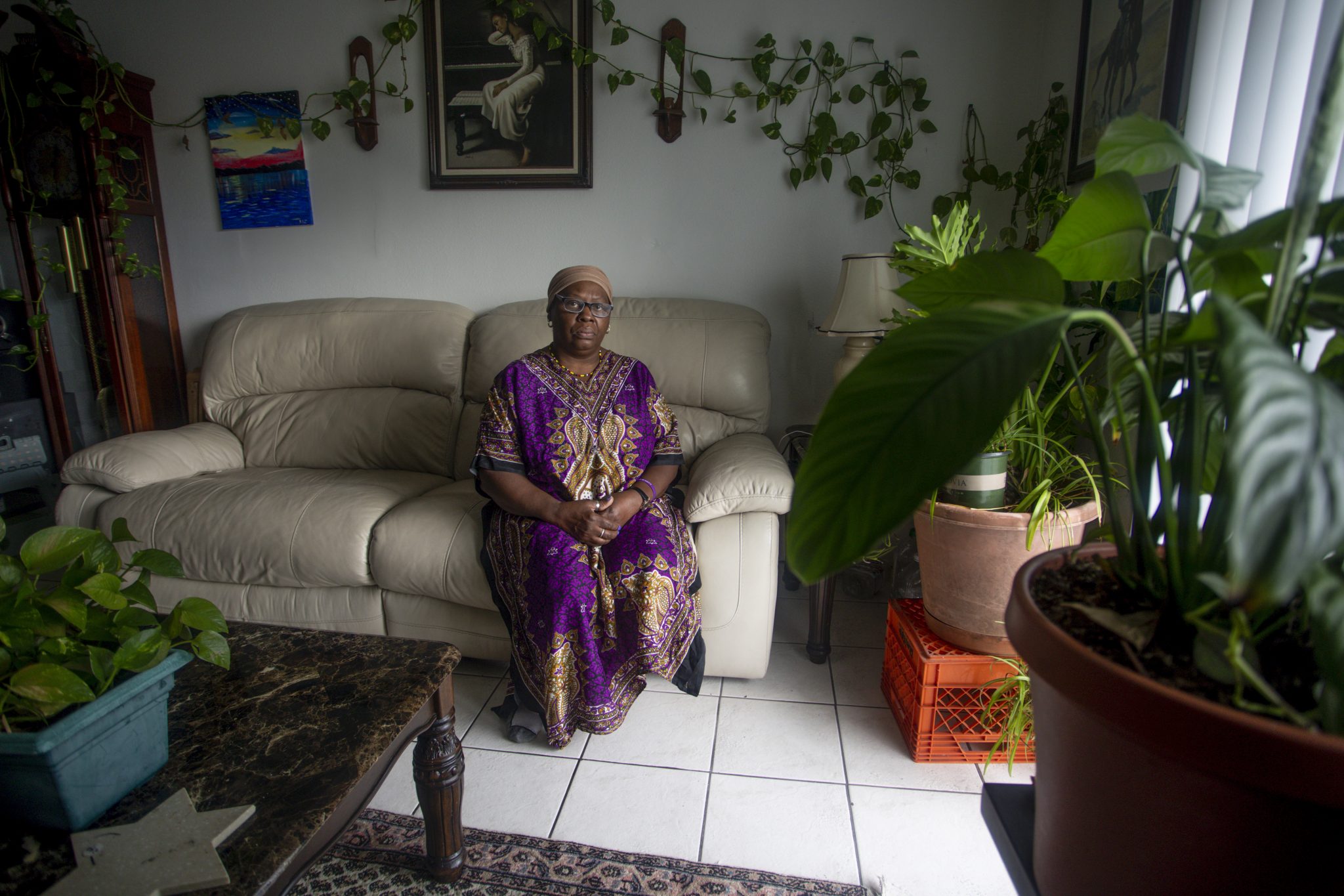 Yochebed Israel, 59, poses for a portrait inside her Tampa, Florida, apartment on Monday, Aug. 17, 2020. Israel, a nursing assistant, found an eviction notice on her door in May after being unable to pay rent since she contracted COVID-19 from her daughter in April, and could not return to work. “There’s a lot of despair in this situation,” Israel said. “Not only are you sick from COVID-19, you miss work, you miss your job, you miss getting paid, you miss a lot of things that dominoes into this situation.” (Ivy Ceballo)