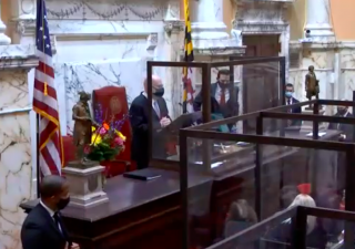 ANNAPOLIS – A congregation of family and close friends follow the late Sen. Mike Miller’s casket inside the Maryland State House in Annapolis on Jan. 21, 2021. (Jack Hogan/Capital News Service)