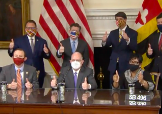 Gov. Larry Hogan, R, Senate President Bill Ferguson, D-Baltimore, and House Speaker Adrienne Jones, D-Baltimore, sign the RELIEF act into law on Jan 15 in Annapolis. (Photo Screenshot: Catherine Scott/Capital News Service)