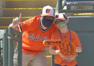 Orioles fans pose for a picture at a spring training game in Sarasota, Florida, on March 10 where a mask mandate was enforced. (Photo credit: Baltimore Orioles.)