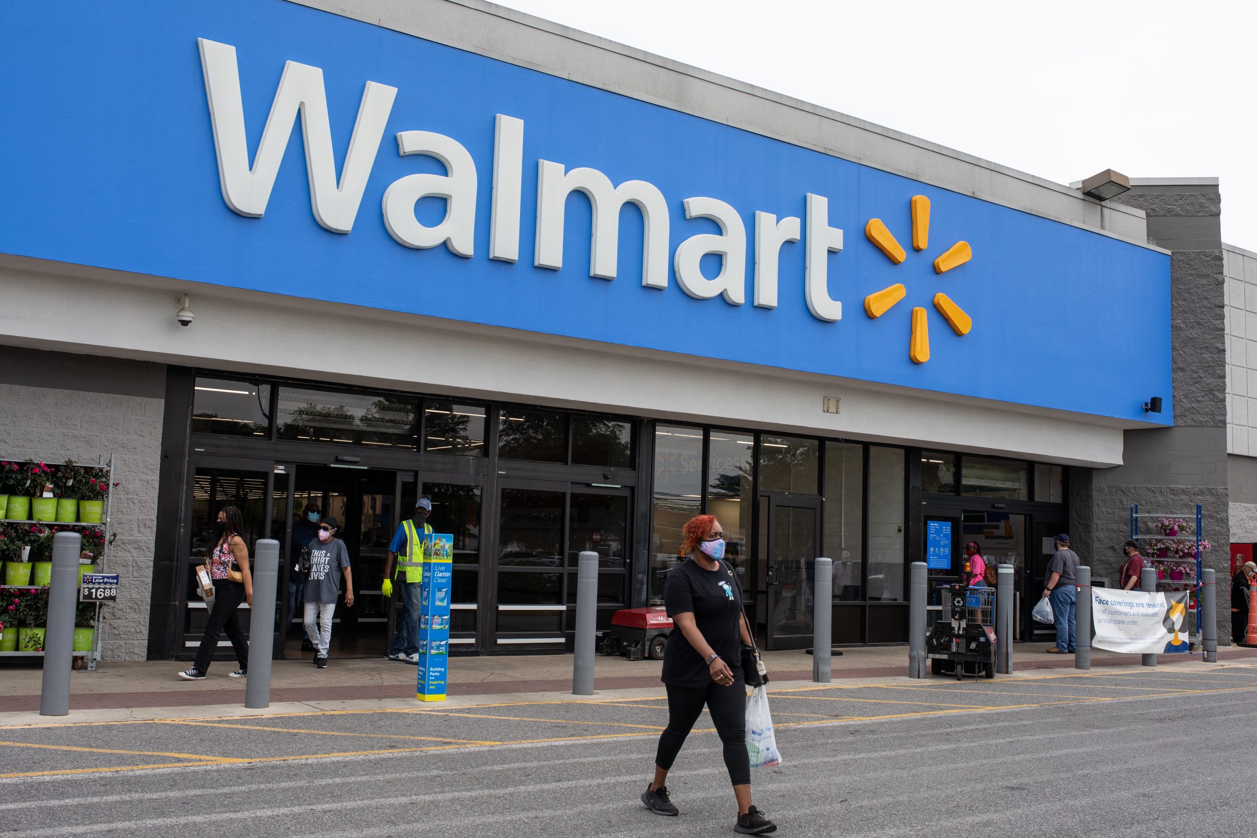 Customers walking out of a Walmart store during the COVID-19 pandemic