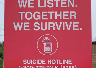 A sign at the end of the New Carrollton Metro Station showing the National Suicide Prevention Lifeline on Sept. 18, 2021. Capital News Service photo by Kelly Livingston.
