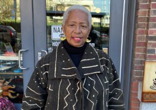Wanda Watts stands in front of a restaurant in Baltimore. Photo by Grace Kamin/Capital News Service