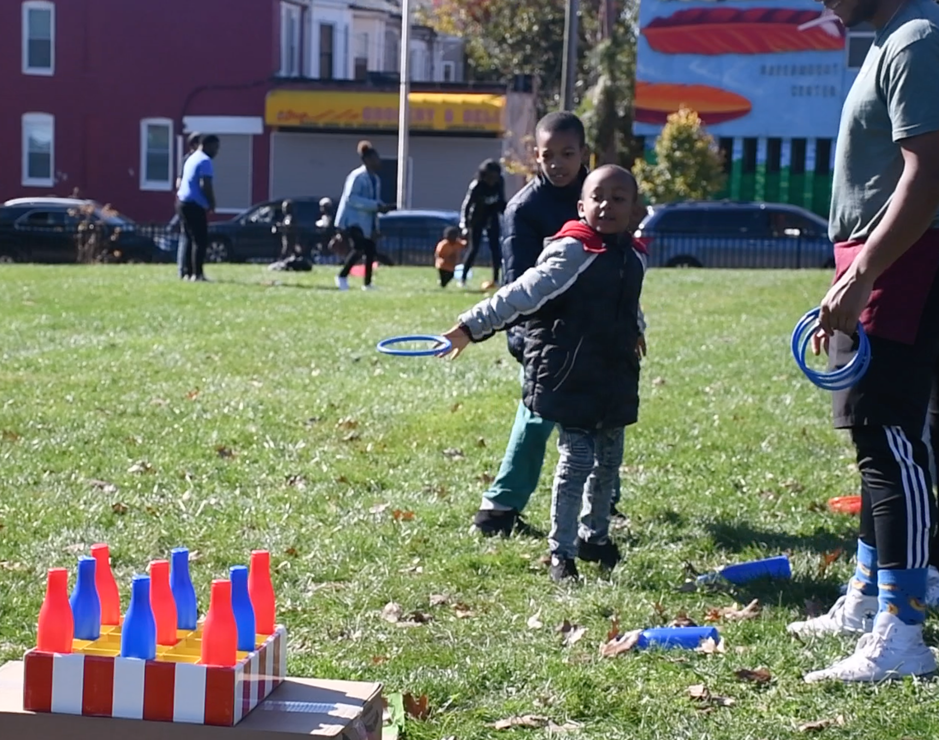 A child plays ring toss at the East Baltimore Graffiti Church's Fall Festival. (Photo by Olivia Wolfson/Capital News Service)