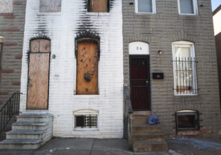 A vacant property juxtaposes a residential property directly next to it in McElderry Park. (Photo: Esther Frances/Capital News Service)