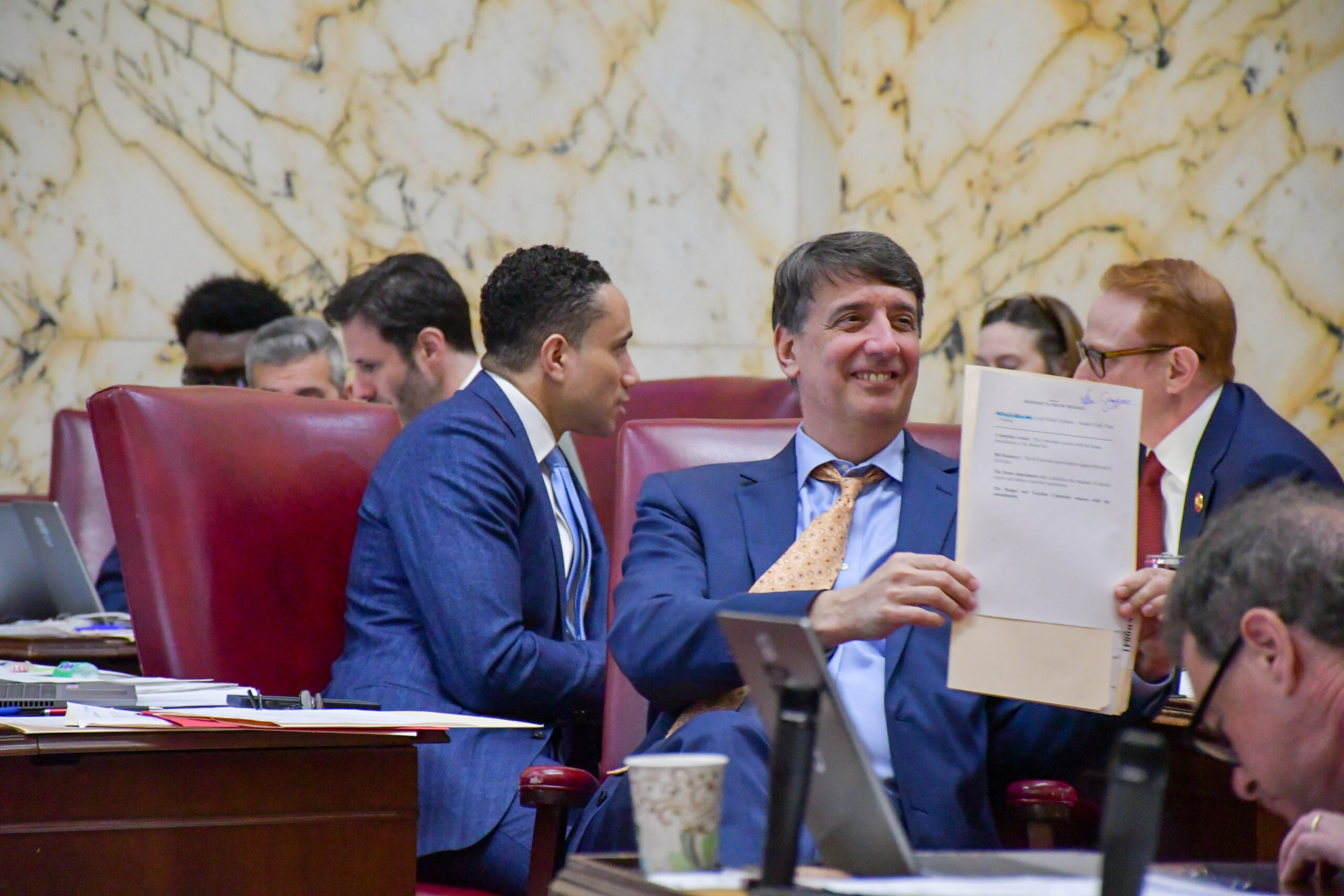 Sen. Guy Guzzone, D-Howard, shows a note to his colleagues. (Christine Zhu/Capital News Service)