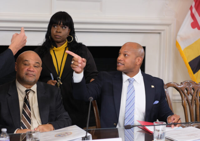 State Treasurer Dereck Davis (left), Board of Public Works Operations Manager Lisa Johnson (center) and Gov. Wes Moore (right), chatting after public works meeting, Wednesday Nov. 29, 2023. (Capital News Service/Tommy Tucker)