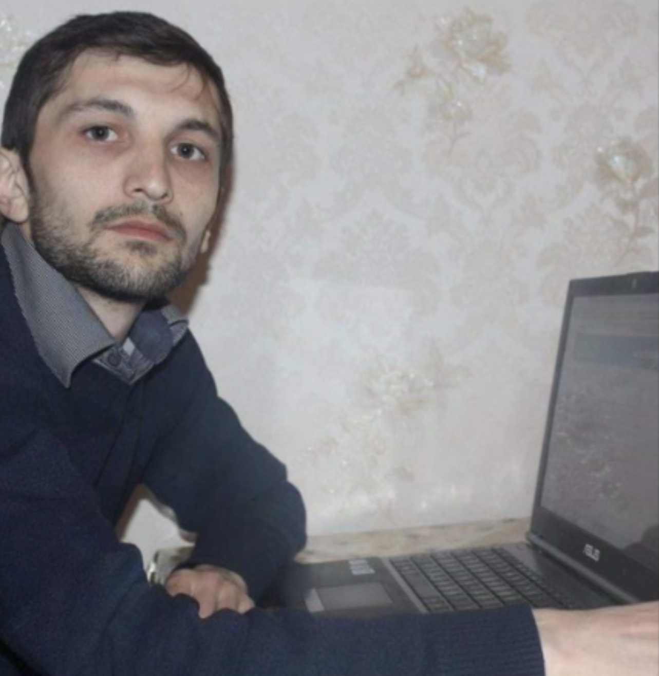 Polad Aslanov sits down to use his computer. (Courtesy of Gulmira Aslanova and Fuad Hasanov)